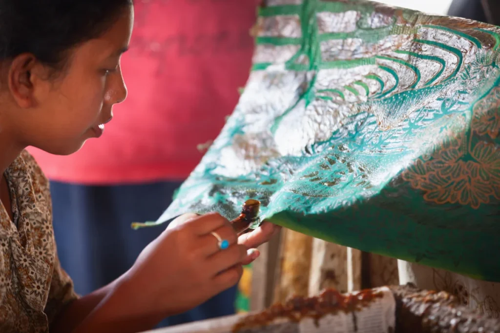 Balinese woman making traditional batik