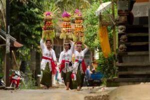 Balinese people walking while carrying offerings