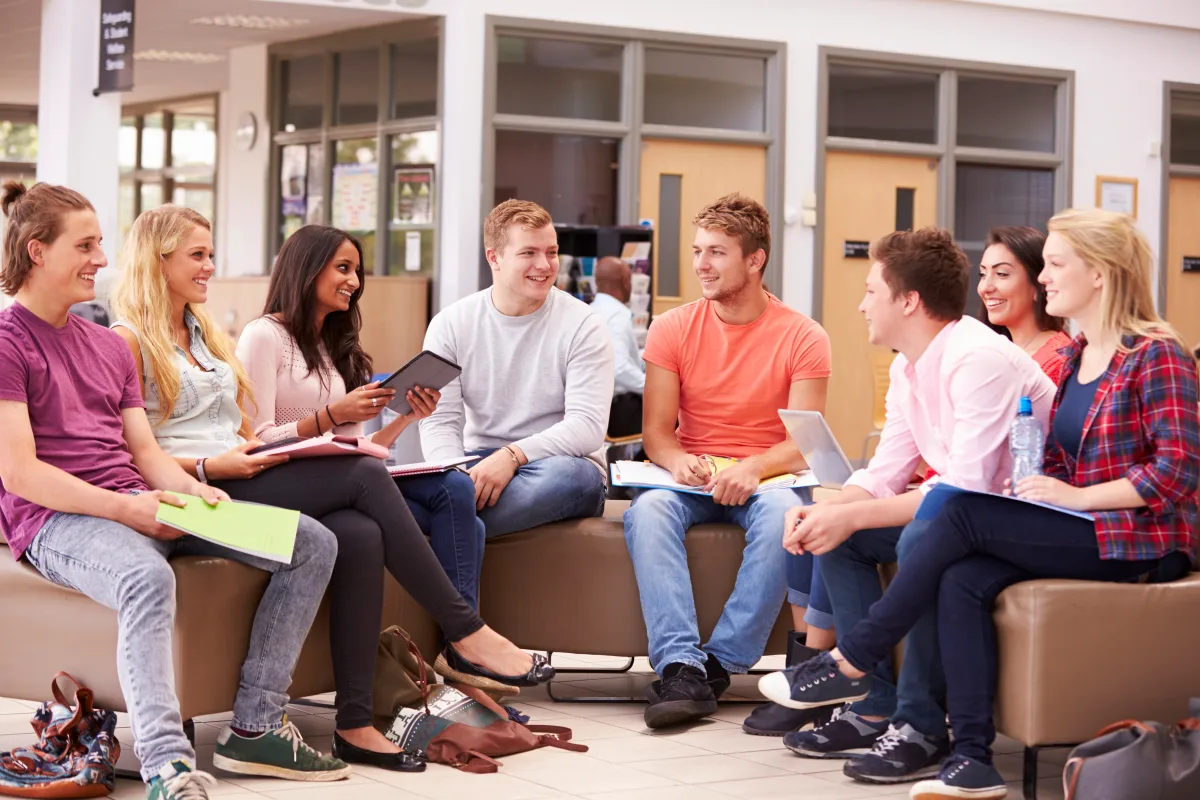 University students discussing a collaborative experiential learning project outdoors