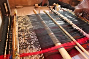 Traditional wooden loom used to weave colorful Indonesian fabric by hand