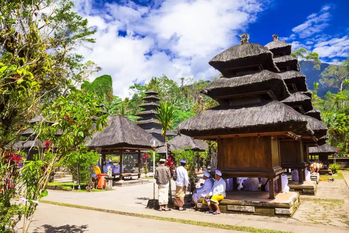 Balinese community participating in a religious ceremony at a temple in Bali